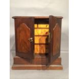 A mahogany miniature cabinet with lancet detailing on the doors.