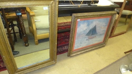 A giltwood framed rectangular wall mirror and a silver-gilt framed monet print (2)