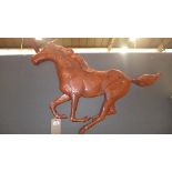 A carved wooden wall hanging horse