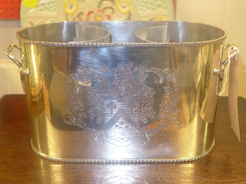 A silver plated 2 wine cooler with coat of arms on sides