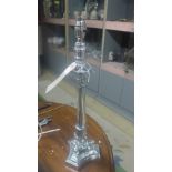 A single silverplated empire style table lamp on triform base,