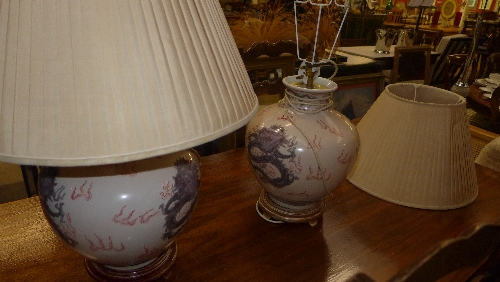 A pair of Chinese style lamps with dragon detail and matching shades