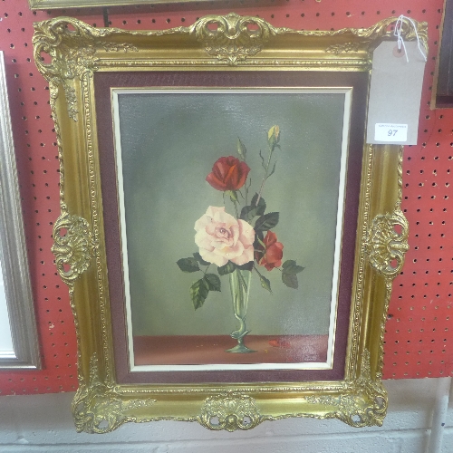 An oil on canvas still life of roses in a bud vase signed indistinctly