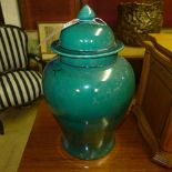 A pair of green glazed temple jars