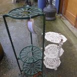 Two cast iron garden stands and a collection of plant pots