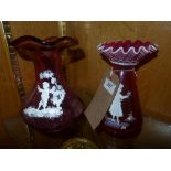 A pair of similar cranberry Mary Gregory style vases