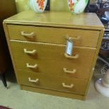 A 1950s honey oak chest of four long drawers