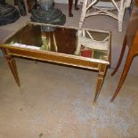 A Venetian style mirror topped low table on tapered supports