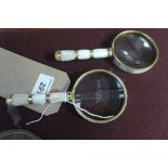 A pair of magnifying glasses with mother of pearl handles