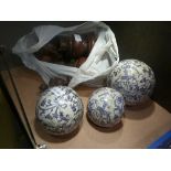 A set of three porcelain blue and white spheres and a collection of wooden turnings