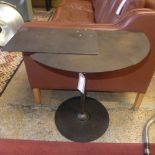 A cheret style blackened steel occasional table with an adjustable open top on pedestal base