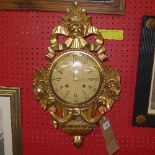 A giltwood ornate charter wall hanging clock