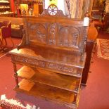 A C19th French carved oak buffet the carved back having traditional scenes of relief above two