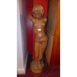 A carved wooden sculpture of a semi nude Classical style female inscribed Jan Vols to the base 112cm