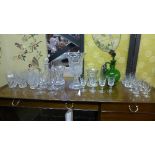 A collection of glassware including decanter vase and green claret jug