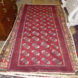 A fine North East Persian Turkoman rug 240 cm x 120 cm repeating ghoul motifs on  terracotta field