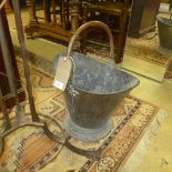 A brass coal bucket on helmet form and an oak stick stand (2)