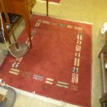 A C20th woollen Gabbeh rug, red ground geometric motifs