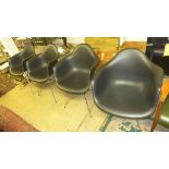 A set of four 20th century contemporary tub form chairs with black fibreglass backs and seats on