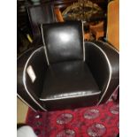 A contempory Jean Renoir design dark brown faux leather armchair of angular form with ivory piped