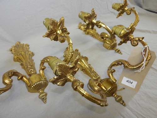 A set of three 20th century ornate gilt metal three branch wall lights