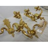 A set of three 20th century ornate gilt metal three branch wall lights