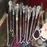 A collection of silver hooks together with a silver plated pair of grape scissors