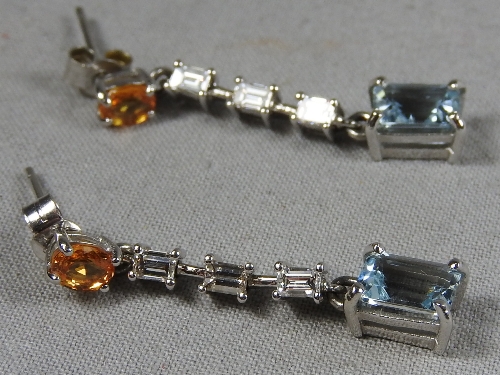 A pair of 14ct square cut diamond and aquamarine earrings.