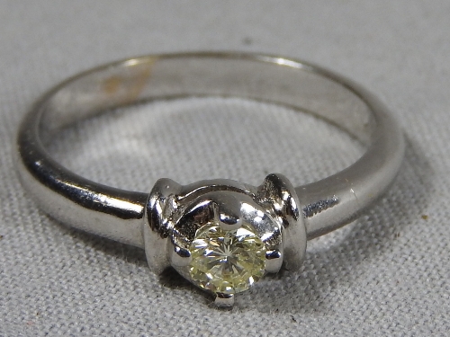 A C14ct white gold solitaire diamond ring.