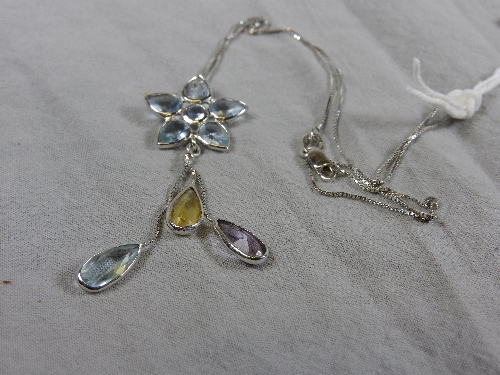 A 14ct white gold flower form pendant inset multicoloured stones on a fine link chain. - Bild 2 aus 2