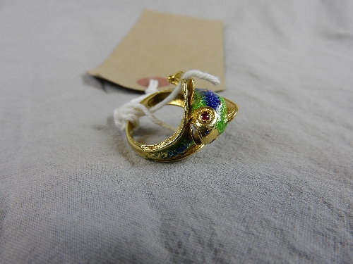 An 18ct yellow gold and enamel dress ring in the form of a dolphin on the crest of a wave