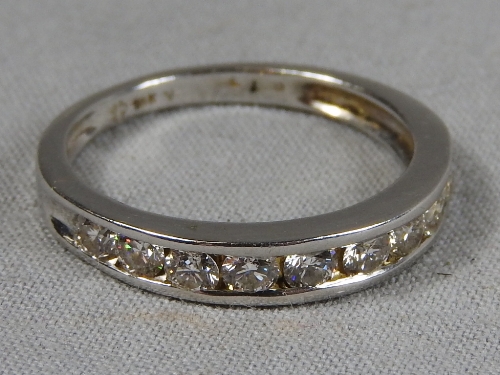 An 18ct white gold half hoop diamond ring.