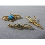 A set of three gold brooches,