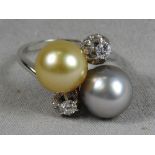 An C18th white gold ladies dress ring set twin diamonds and two colour pearls.