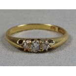 A Victorian 18ct yellow gold three stone diamond ring in a claw setting.