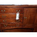An Edwardian inlaid mahogany music cabinet with a bank of four drawers flanked to the right by a