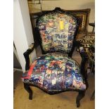 A French design ebonised open armchair upholstered in comic fabric on cabriole supports