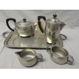 An early 20th Arts and Crafts Tudric pewter tea service including tray, pots, creamer and sucrier