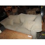 A Contemporary cream upholstered two seater sofa