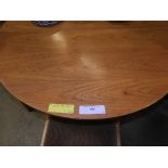 A 1970s G-plan style teak circular dining/breakfast table on tapered supports, with four similar