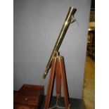 A brass telescope on an adjustable tear tripod stand