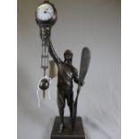A Victorian design bronzed aviator novelty clock in the form of a pilot holding propeller