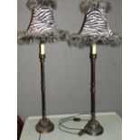 A pair of contemporary wrought iron lamps with zebra shades height 100cm