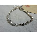 An 18ct white gold link form bracelet set round cut diamonds