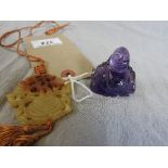 A fade pendant and an amethyst seated Buddha figure (2)