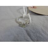 An 18ct white gold solitaire diamond ring set diamond chip shoulders (diamond approx .8cts)