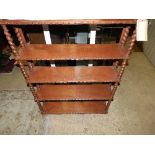 A late 19th Century Victorian carved oak set of hanging shelves of four rectangular tiers on