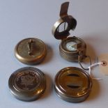 A set of four brass compasses