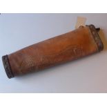 A vintage leather quiver with a hand sta