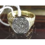 An 18ct yellow gold gentlemans dress ring set diamonds with an oval setting